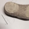 leather patches sewn on the soles of wooppers slippers